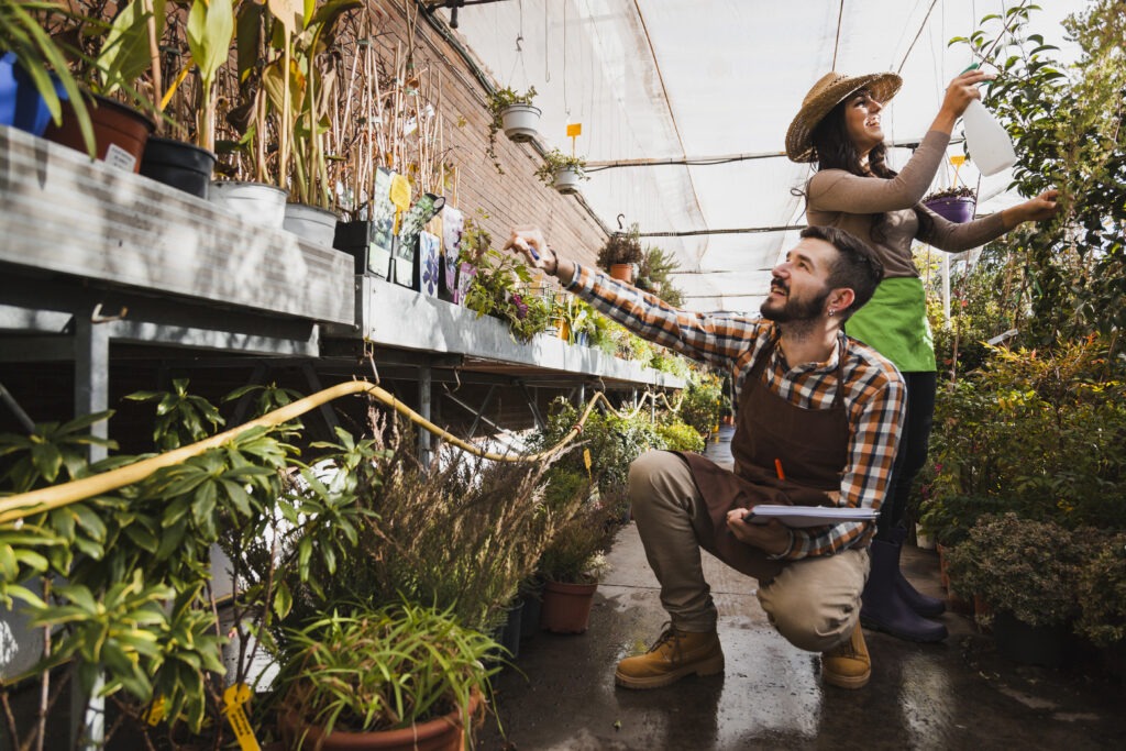 People working together in an urban greenhouse garden with plants